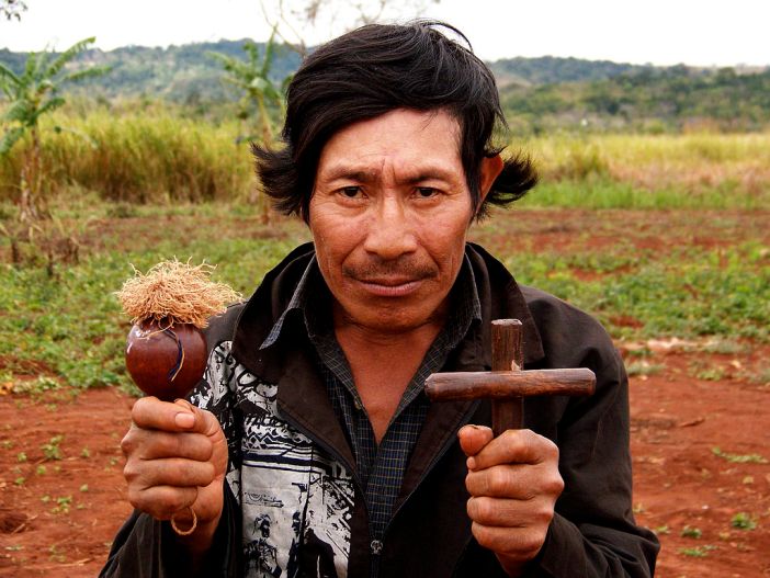 Guarani spiritual leader holding cross and gourd rattle, Paraguay, 2006 photo courtesy of Frank O'Weaver CC by SA 3.0